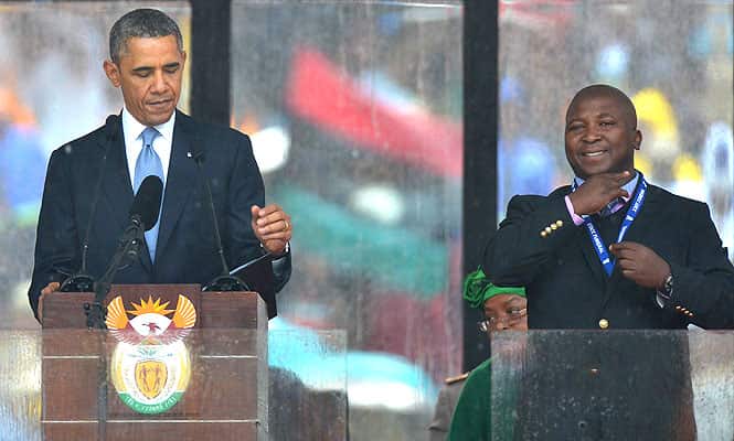 In this picture taken on December 10, 2013 US President Barack Obama delivers a speech next to a sign language interpreter (R) during the memorial service for late South African President Nelson Mandela at Soccer City Stadium in Johannesburg. AFP phot)