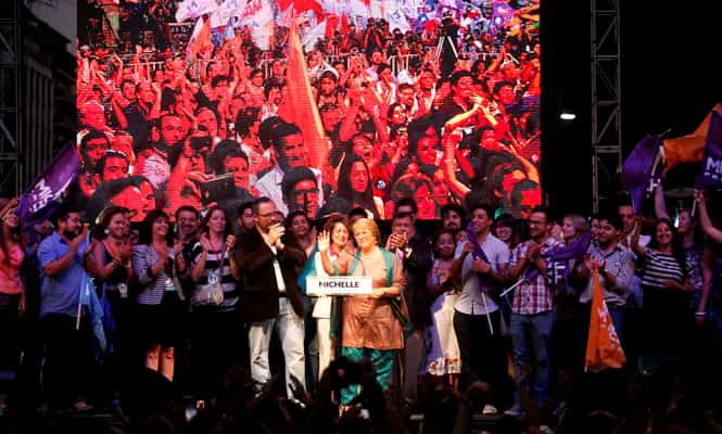 Michelle Bachelet waves during an event after her center-right opponent Evelyn Matthei conceded defeat. (AP)</font></em></strong) Michelle Bachelet waves during an event after her center-right opponent Evelyn Matthei conceded defeat. (AP)</font></em></strong)