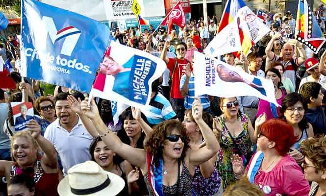 Supporters of two-time president Michelle Bachelet wave flags in Santiago, Chile. (AP)</font></em></strong) Supporters of two-time president Michelle Bachelet wave flags in Santiago, Chile. (AP)</font></em></strong)