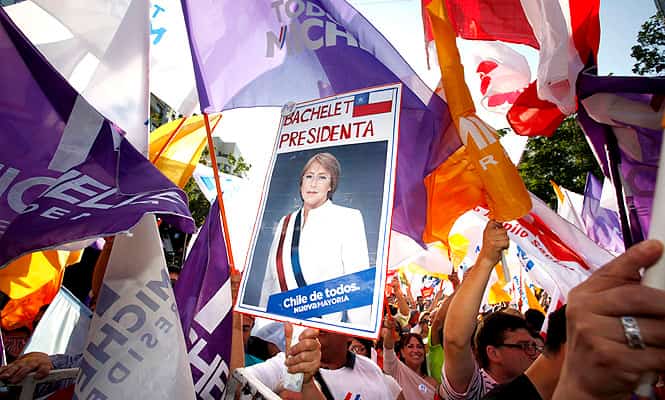 Supporters of Chilean socialist candidate for the New Majority coalition, Michalle Bachelet, celebrate in front of the party's headquarters in Santiago. (AFP) </font></em></strong) Supporters of Chilean socialist candidate for the New Majority coalition, Michalle Bachelet, celebrate in front of the party's headquarters in Santiago. (AFP) </font></em></strong)