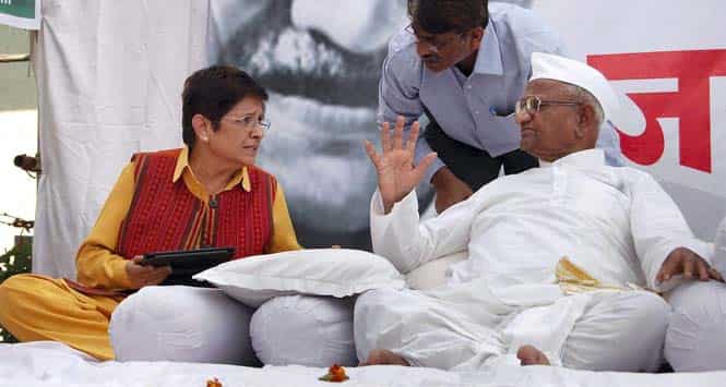 Former IPS officer and social activist Kiran Bedi having a word with Anna Hazare during the second day of his indefinite hunger strike for Jan Lokpal Bill, at his village in Ralegan Siddhi. PTI Photo