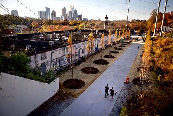 In this file photo, a couple walks along the Atlanta BeltLine as the midtown skyline stands in the background in Atlanta. (AP Photo)
</div) In this file photo, a couple walks along the Atlanta BeltLine as the midtown skyline stands in the background in Atlanta. (AP Photo)
</div)