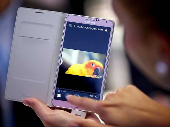 A woman tests a Samsung Galaxy Note 3 Smartphone at the IFA, one of the world's largest trade fairs for consumer electronics and electrical home appliances in Berlin, Germany. (AP photo)
</div) A woman tests a Samsung Galaxy Note 3 Smartphone at the IFA, one of the world's largest trade fairs for consumer electronics and electrical home appliances in Berlin, Germany. (AP photo)
</div)