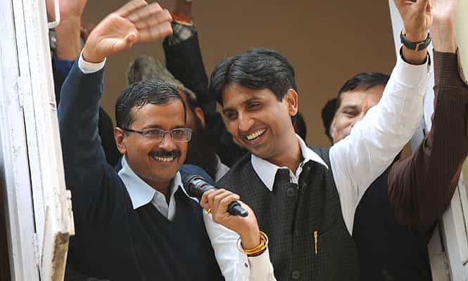 Arvind Kejriwal waves to supporters after AAP's strong performance in the Delhi polls.
