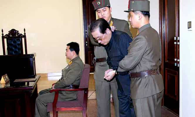 Jang Song-Thaek (in dark blue) being escorted to court on December 12, 2013. North Korea has executed the uncle of its leader Kim Jong-un after a shock purge. AFP Phot)