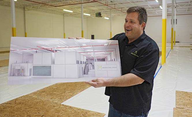 In this Dec. 5, 2013, photo, Pete Williams holds a drawing of the new grow facility that is being built at the Medicine Man dispensary and grow operation in northeast Denver. (AP Photo)</font></em></strong>
</div) In this Dec. 5, 2013, photo, Pete Williams holds a drawing of the new grow facility that is being built at the Medicine Man dispensary and grow operation in northeast Denver. (AP Photo)</font></em></strong>
</div)