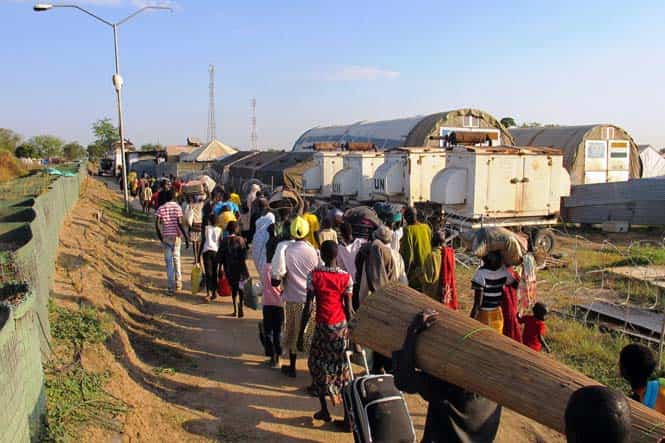 A handout photo from Unmiss shows civilians walking inside the Unmiss compound in Bor. (AFP Photo/Unmiss) </div)