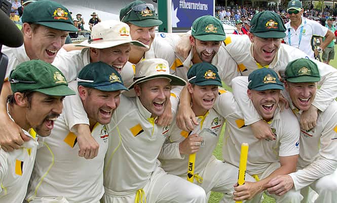 The Australian cricket team celebrate after winning back the urn from England on the fifth day of the third Ashes cricket Test match in Perth.  (AFP)