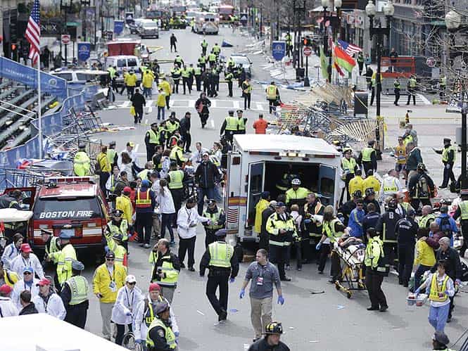 Medical workers aid injured people at the finish line of the 2013 Boston Marathon following an explosion in Boston. (AP Photo)</em) Medical workers aid injured people at the finish line of the 2013 Boston Marathon following an explosion in Boston. (AP Photo)</em)