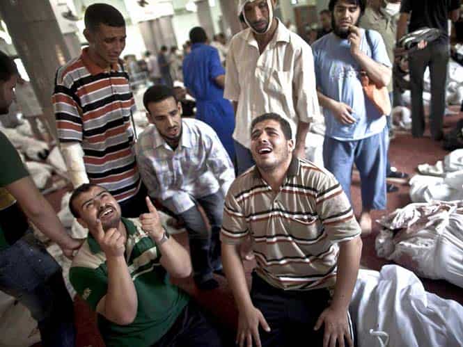 Egyptians mourn at a mosque in Cairo where lines of bodies wrapped in shrouds are laid out following a crackdown on the protest camps of supporters of ousted Islamist president Mohamed Morsi the previous day. (AFP Photo) Egyptians mourn at a mosque in Cairo where lines of bodies wrapped in shrouds are laid out following a crackdown on the protest camps of supporters of ousted Islamist president Mohamed Morsi the previous day. (AFP Photo)