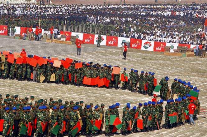 Members of Bangladesh Army wait to participate in the formation of the national flag during Victory Day celebrations in Dhaka. (AP photo)</em)