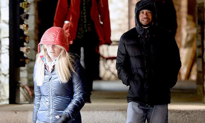 US golfer Tiger Woods (R) and US Alpine skier Lindsey Vonn (L) walk on December 20, 2013, in Val d’Isère, in the French Alps.(AFP photo)