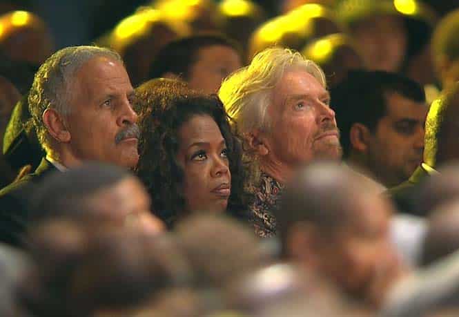 US talk show host Oprah Winfrey, her husband Stedman Graham (L) and English businessman Richard Branson (R) watching the funeral service of late South African President Nelson Mandela. (AFP)</em></strong)