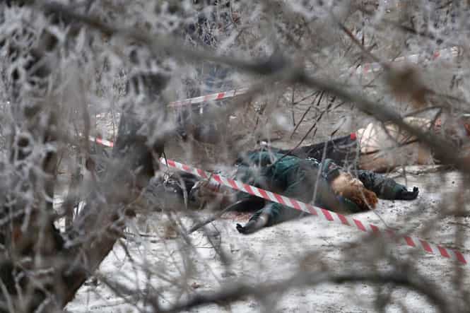 Victims' bodies lie outside a wreckage of a trolleybus in Volgograd after a bomb blast killed at least 14 people. (AP photo)</strong) Victims' bodies lie outside a wreckage of a trolleybus in Volgograd after a bomb blast killed at least 14 people. (AP photo)</strong)