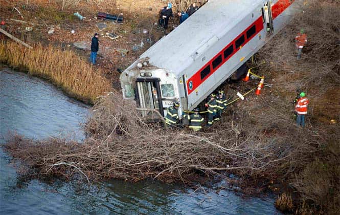 Emergency workers examine the site of a Metro-North train derailment in the Bronx borough of New York. (Reuters Photo)</em></strong) Emergency workers examine the site of a Metro-North train derailment in the Bronx borough of New York. (Reuters Photo)</em></strong)