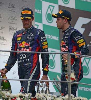 Vettel with teammate Webber after their 1st and 2nd place finishes at the F1 Malaysian GP. (AFP file photo)