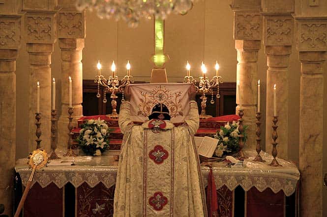 Bishop Malki Murad conducts the midnight Christmas Mass at the Saint Afram Syrian Orthodox Church in Amman, Jordan. (AP)</font></em></strong) Bishop Malki Murad conducts the midnight Christmas Mass at the Saint Afram Syrian Orthodox Church in Amman, Jordan. (AP)</font></em></strong)
