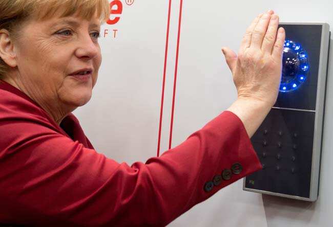 German Chancellor Angela Merkel smiles as access is granted to her at the stand of security equipment maker tisoware during her opening tour of the CeBIT computer fair in Hannover, northern Germany, Tuesday, March 5, 2013. Photo: AP/dpa, Julian Stratenschulte German Chancellor Angela Merkel smiles as access is granted to her at the stand of security equipment maker tisoware during her opening tour of the CeBIT computer fair in Hannover, northern Germany, Tuesday, March 5, 2013. Photo: AP/dpa, Julian Stratenschulte