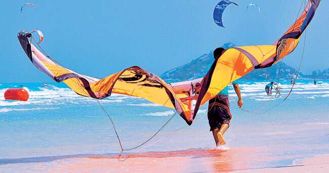 SURF’s UP! Hua Hin’s calm wind makes it ideal for kiteboarding, to watch or participate. SURF’s UP! Hua Hin’s calm wind makes it ideal for kiteboarding, to watch or participate.