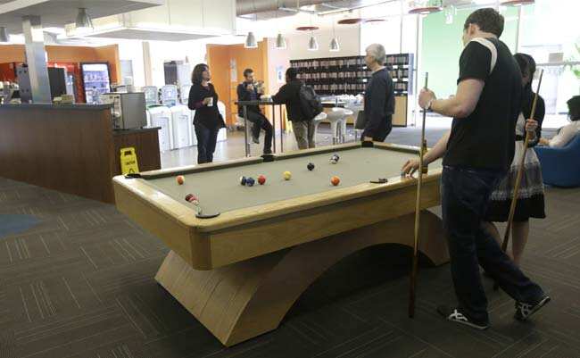 Google employees shoot pool at in a break room at the Google campus in Mountain View, Calif., Friday, March 15, 2013. Photo:AP/Jeff Chiu Google employees shoot pool at in a break room at the Google campus in Mountain View, Calif., Friday, March 15, 2013. Photo:AP/Jeff Chiu