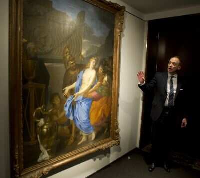A Christie's employee beside The Sacrifice of Polyxena by Charles Le Brun on January 24, 2013 at Christie's in New York (Photo Courtesy: AFP Photo)