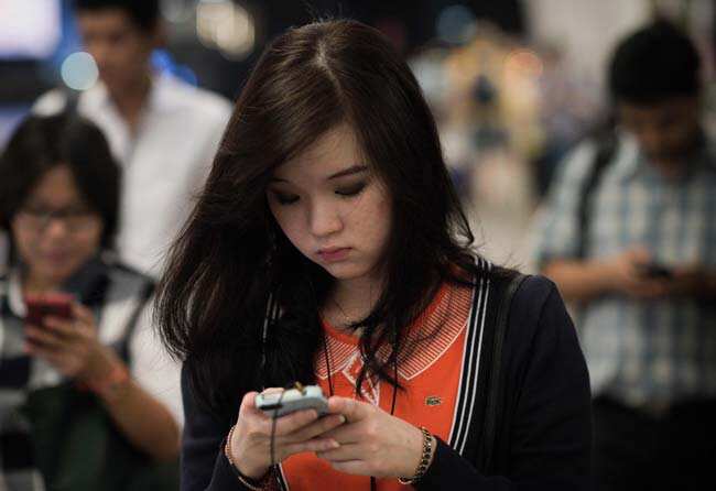 People using their smartphones while walking on the platform of a BTS train station in Bangkok. Photo: AFP/ Nicolas Asfouri People using their smartphones while walking on the platform of a BTS train station in Bangkok. Photo: AFP/ Nicolas Asfouri