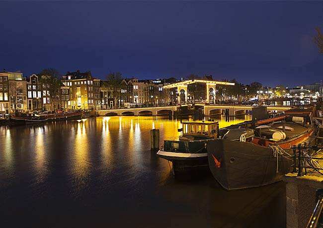 Nightview of the Magere Brug, the skinny bridge,the most famous bridge in Amsterdam. The Royal celebrations in the Netherlands this week put the country and the capital Amsterdam on front pages and television screens around the world with an orange splash. Photo: Reuters/Michael Kooren