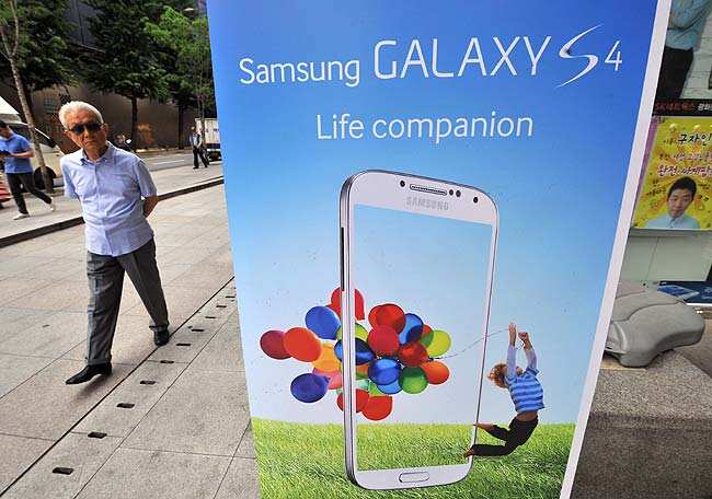 A man walks past a signboard advertising Samsung Electronics smart phones at a Samsung mobile shop in Seoul. Photo:AFP / Jung Yeon-Je A man walks past a signboard advertising Samsung Electronics smart phones at a Samsung mobile shop in Seoul. Photo:AFP / Jung Yeon-Je