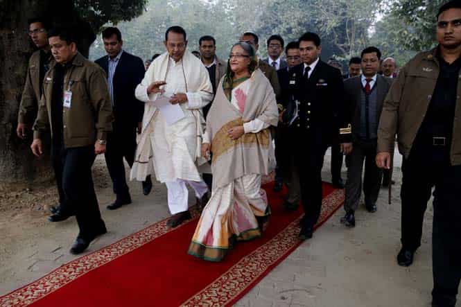 Bangladesh's Prime Minister Sheikh Hasina, center, walks with information minister Hasanul Haq Inu as she arrives for a press conference in Dhaka, Bangladesh. (AP Photo)
</div) Bangladesh's Prime Minister Sheikh Hasina, center, walks with information minister Hasanul Haq Inu as she arrives for a press conference in Dhaka, Bangladesh. (AP Photo)
</div)