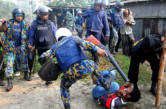 Bangladeshi policemen kick a suspect, following an attack on a polling station, in Bogra, north of Dhaka, Bangladesh. (AP Photo)
</div) Bangladeshi policemen kick a suspect, following an attack on a polling station, in Bogra, north of Dhaka, Bangladesh. (AP Photo)
</div)