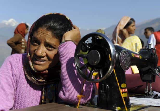 Binita Devi, who lost her husband during the massive Uttarakhand floods last June, takes part in vocational training at Deoli-Bhanigram village in Uttarakhand. (AFP Photo) 
</div)