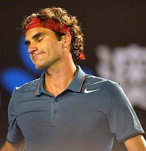 Roger Federer of Switzerland reacts while playing against Rafael Nadal of Spain during their men's singles semi-final match on day 12 of the 2014 Australian Open. (AFP Photo) 
</div)