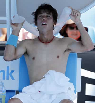 Kei Nishikori of Japan cools down with ice pack around his neck during their second round match against Dusan Lajovic of Serbia at the Australian Open in Melbourne. (AP Photo)
</div) Kei Nishikori of Japan cools down with ice pack around his neck during their second round match against Dusan Lajovic of Serbia at the Australian Open in Melbourne. (AP Photo)
</div)