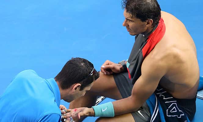 Rafael Nadal of Spain receives medical treatment to a blister on his hand during his quarterfinal against Grigor Dimitrov of Bulgaria at the Australian Open tennis championship in Melbourne. (AP Photo) 
</div)