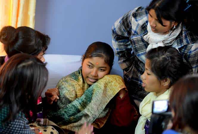 Nepalese indentured 'kamlari' girl Jujri Tharu speaks to activists after being rescued from her workplace in Kathmandu. (AFP)</strong) Nepalese indentured 'kamlari' girl Jujri Tharu speaks to activists after being rescued from her workplace in Kathmandu. (AFP)</strong)
