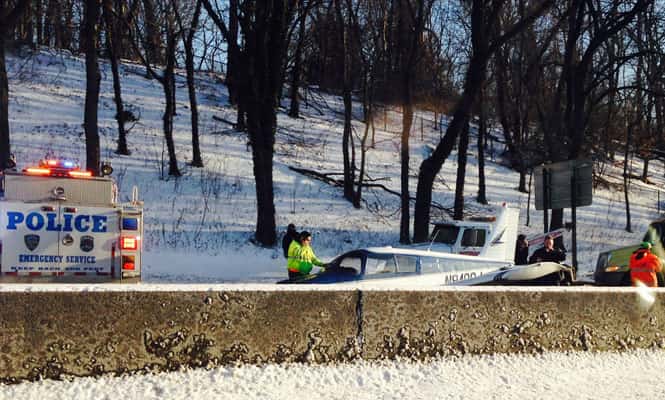 A single engine plane is loaded onto a flat bed truck after landing on Major Deegan Expressway in the Bronx borough of New York. (Reuters Photo)
</div) A single engine plane is loaded onto a flat bed truck after landing on Major Deegan Expressway in the Bronx borough of New York. (Reuters Photo)
</div)