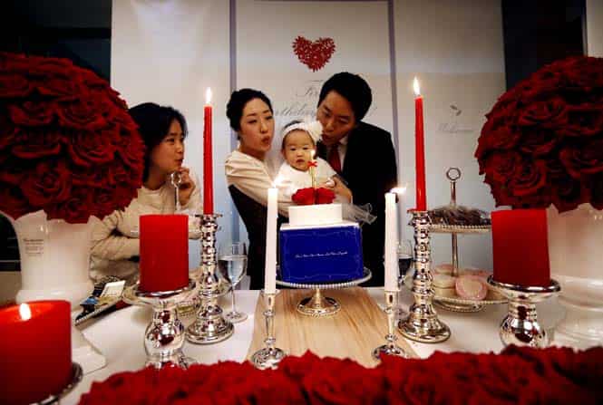 Kim Dot-byul and her parents blow a candle during her first birthday party or Doljanchi in Seoul. (Reuters photo)
</div) Kim Dot-byul and her parents blow a candle during her first birthday party or Doljanchi in Seoul. (Reuters photo)
</div)