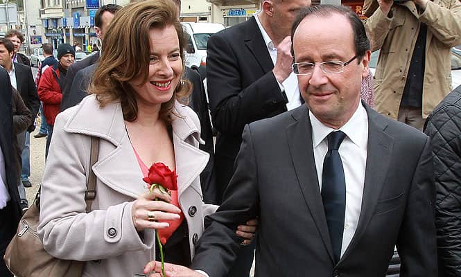 A file photo of Francois Hollande offering a rose to his companion Valerie Trierweiler, in Tulle. (AP photo)</strong)