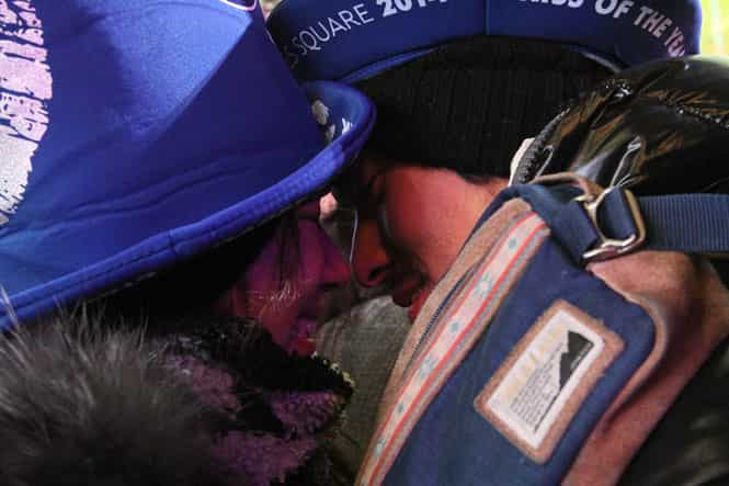 A couple share a moment shortly before midnight as they take part in the New Year's Eve festivities in New York's Times Square. (AP photo)</strong) A couple share a moment shortly before midnight as they take part in the New Year's Eve festivities in New York's Times Square. (AP photo)</strong)