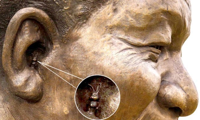 A tiny rabbit is seen in the right ear of a 9-metre (30-feet) bronze statue of the late former South African president Nelson Mandela in Pretoria. (Reuters photo) 
</div)