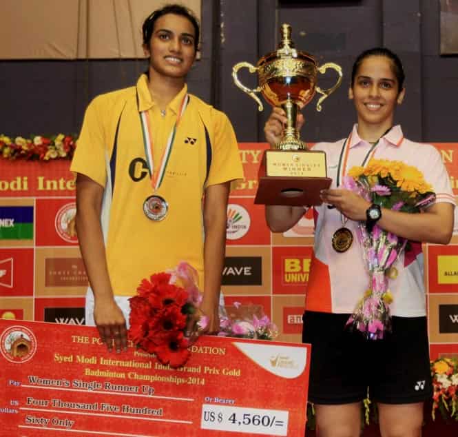 Saina Nehwal with the trophy along with PV Sindhu after the match at BBD Badminton Academy in Lucknow. (PTI Photo)</font></strong) Saina Nehwal with the trophy along with PV Sindhu after the match at BBD Badminton Academy in Lucknow. (PTI Photo)</font></strong)
