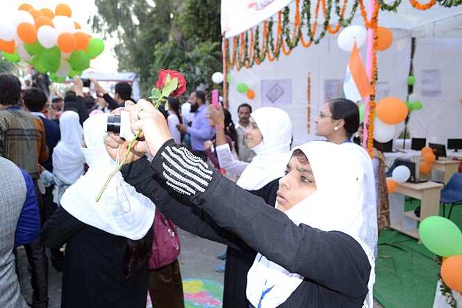 Enthusiastic students try to get a picture of Mulayam Singh Yadav (not seen in the picture) in Rampur on Friday. (HT photo)</i> 
</div)