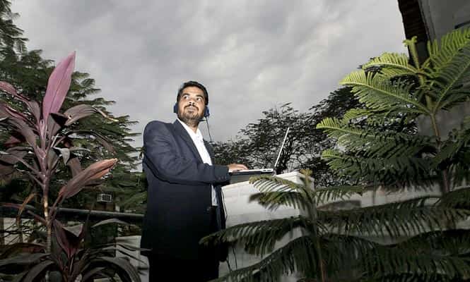 Dr Ankuran Dutta listen radio outside his house balcony in New Delhi. (Photo by Raj K Raj/Hindustan Times)