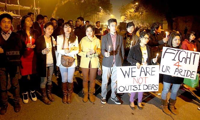 People from northeastern states at a candle light vigil in New Delhi to protest against racism and beating up and killing of a student – Nido Taniam, also spelt Tania – in Delhi. (PTI Photo)</strong> 
</div)