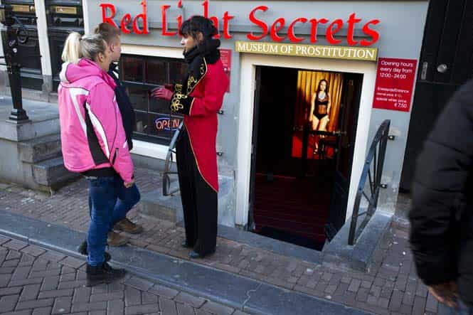 In this photo, a door woman talks to tourists at the entrance of the 'Red Light Secrets' museum in Amsterdam. AP Photo) In this photo, a door woman talks to tourists at the entrance of the 'Red Light Secrets' museum in Amsterdam. AP Photo)