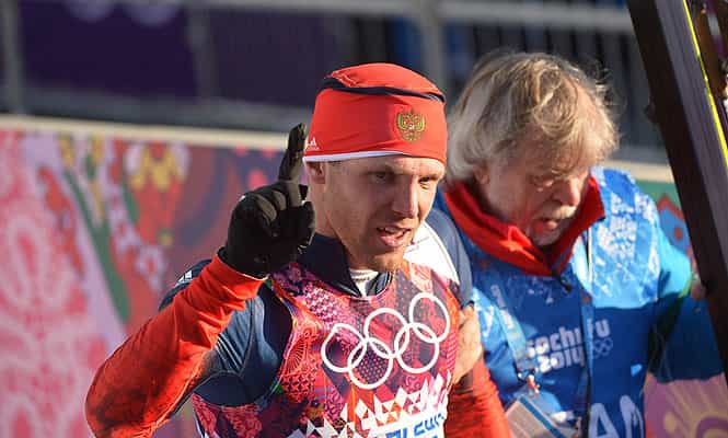 Russia's Anton Gafarov is helped by a volunteer after arriving in the finish area of the Men's Cross-Country Skiing Individual Sprint Free Semifinals during the Sochi Winter Olympics. (AFP Photo) 
</div)