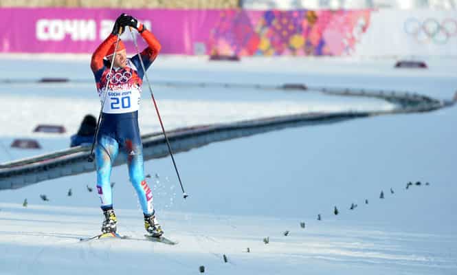 Russia's Anton Gafarov waves upon arrival at the finish area in the Men's Cross-Country Skiing Individual Sprint Free Semifinals during the Sochi Winter Olympics. (AFP Photo) 
</div)