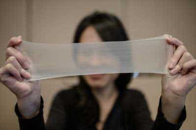 A woman streches a piece of latex from which the world's thinnest latex condoms are made during a press conference in Hong Kong on February 20, 2014. (AFP)</font></strong>
</div) A woman streches a piece of latex from which the world's thinnest latex condoms are made during a press conference in Hong Kong on February 20, 2014. (AFP)</font></strong>
</div)