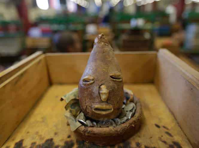 An Elegua, the opener of roads and an important deity in the Yoruba religion made with tobacco leafs, is seen inside at the Corona cigar factory in Havana. (Reuters photo)</strong)