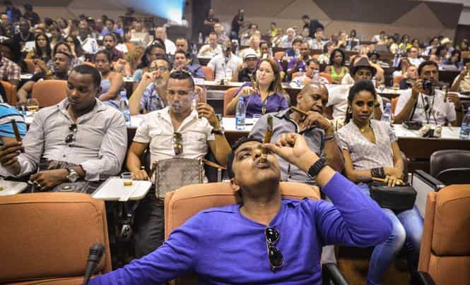 A man smokes a cigar during the contest for the longest ash, during the XVI Havana Cigar Festival, in the Cuban capital. (AFP photo)</strong)